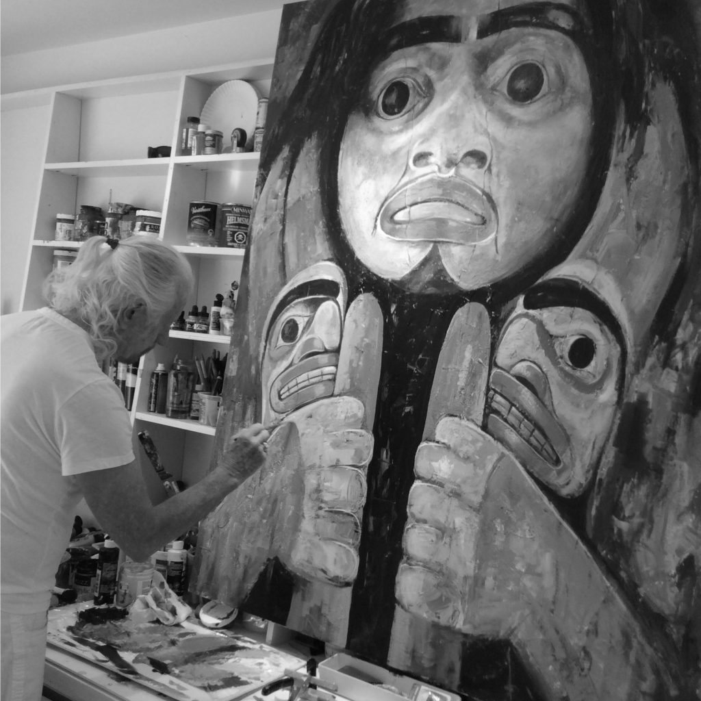 Paul Ygartua painting in his studio a native west coast painting. 